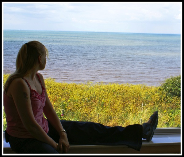 Sarah sat in the window of the lighthouse looking out over the sea