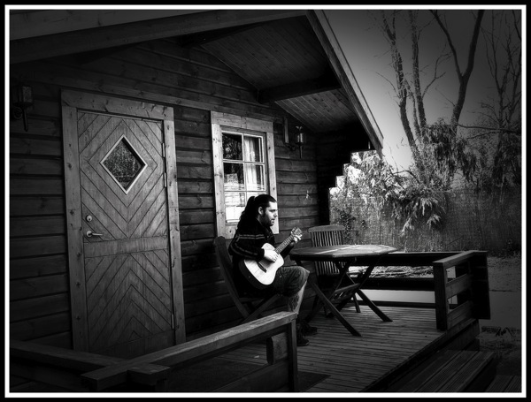 Me playing my baby Taylor on the porch on the log cabin