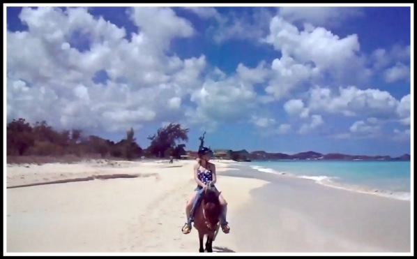Sarah looking out to sea as she rides along the stunning Sandhaven beach