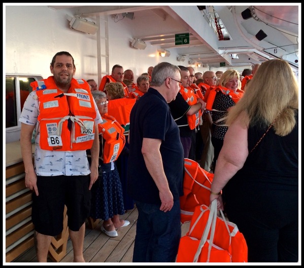 Me in life jacket on the left of the photo, with a lot of other people on deck 9 stood around with life jackets