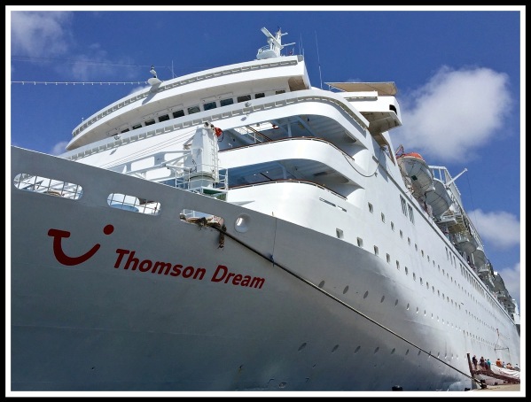 A colour photo of the Thomson Dream cruise ship standing from the dock and looking up