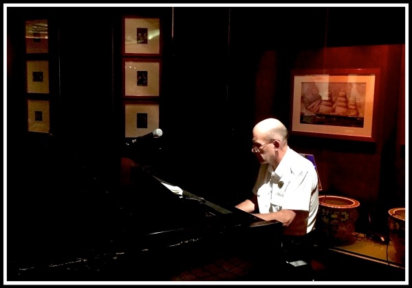Pianist Keith sat playing at the piano