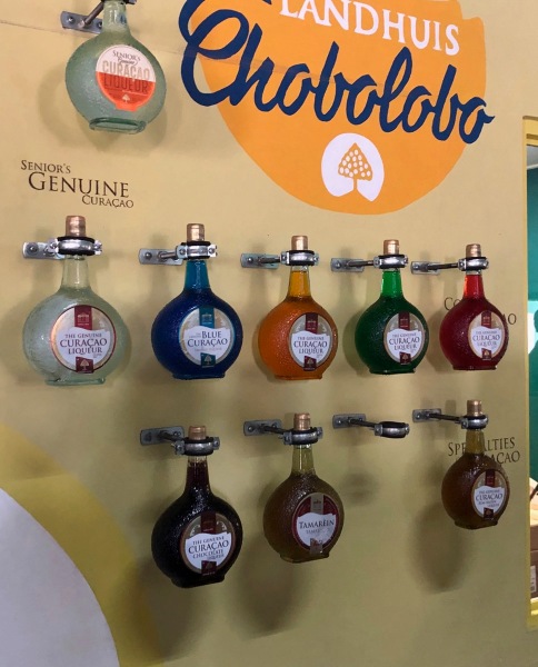 bottles of Curacao hanging on a display wall