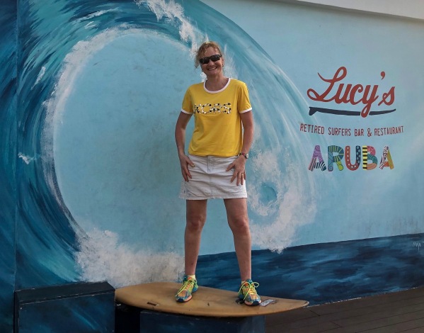 Sarah stood on a surf board in her new yellow Michael Kors t-shirt.