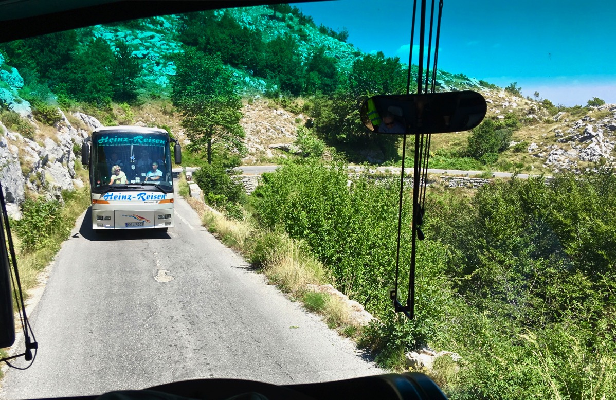 Photo to taken from our front seats in the coach of the very narrow road with a coach facing us and having to reverse 