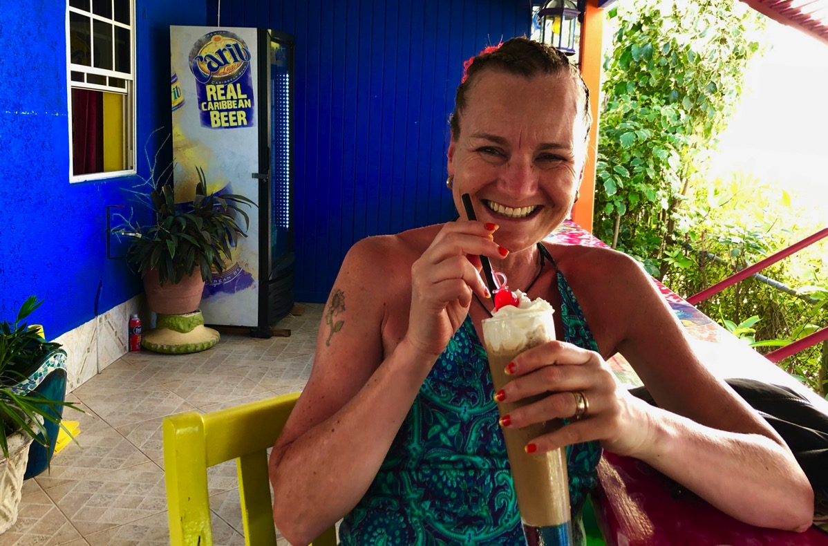 Sarah sat with an iced coffee in the very colourful Sharkey's Tropical Cafe